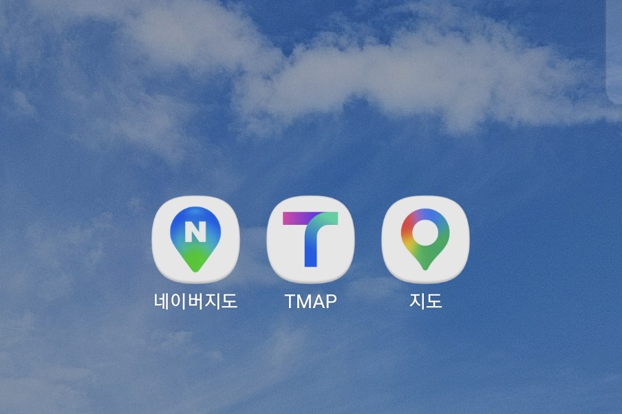 A phone home screen with three map apps side by side: Naver Map (네이버지도), TMAP and Google Maps (지도)