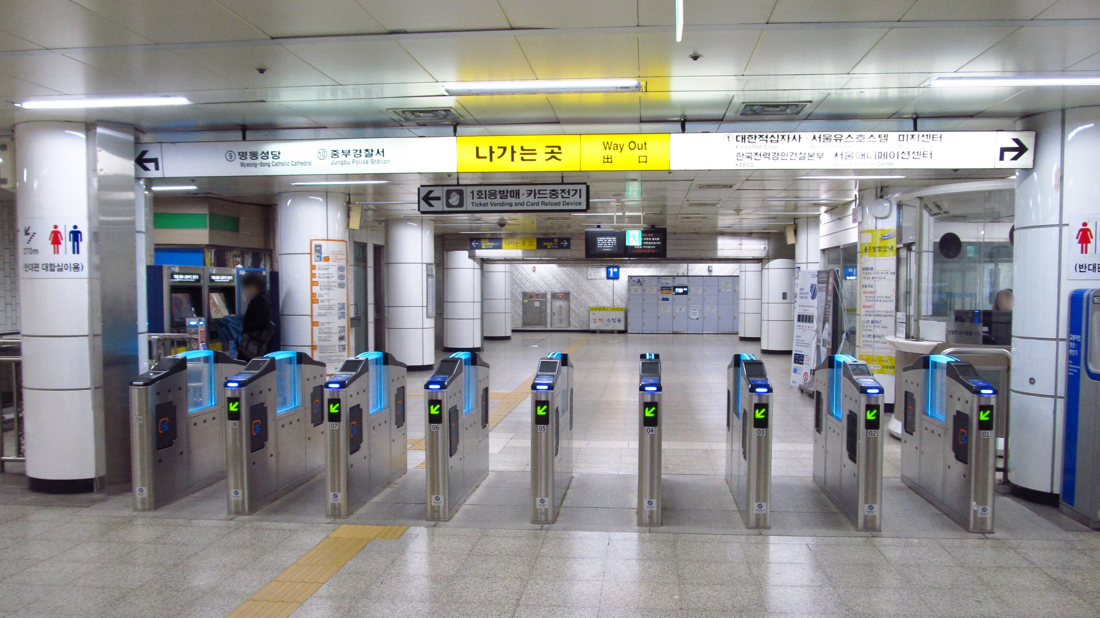 Ticket gates at Myeongdong Station on Seoul Subway Line 4, with card readers on top of each gate