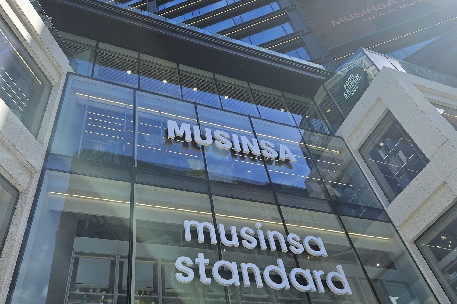 Glass facade with Musinsa and Musinsa Standard signs in Seongsu