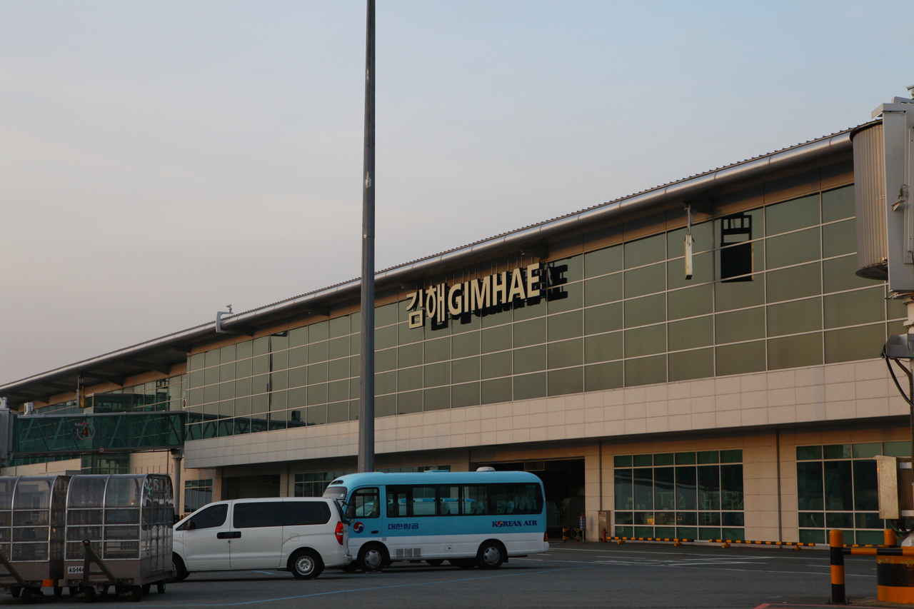 The front of Gimhae International Airport's terminal building in Busan, with taxis lined up outside