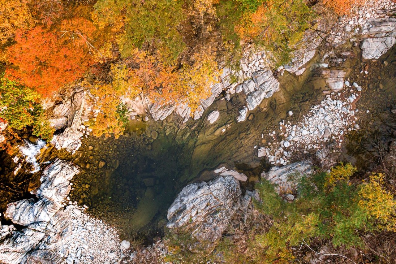Top-down view of a rocky stream in Odaesan National Park framed by autumn trees