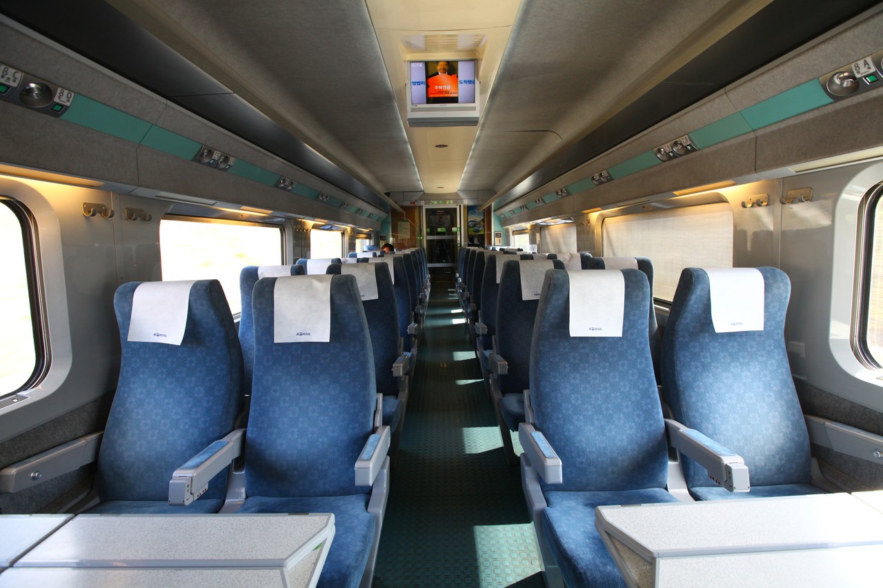 Rows of blue standard-class seats inside a KTX carriage