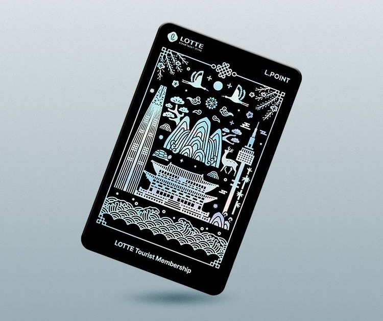 The black LOTTE Tourist Membership Card tilted on a pale grey background, covered in silver hologram line art of palace roofs, mountains, cranes, a deer and two towers