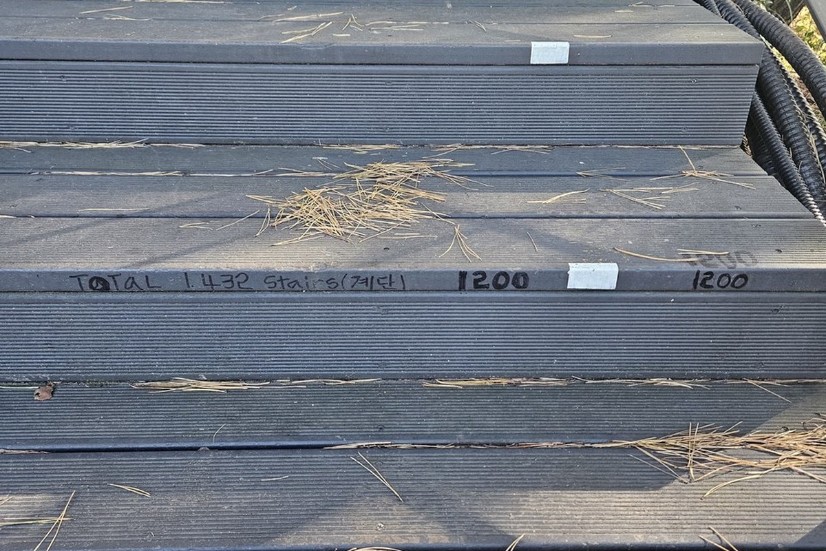 Wooden stair treads on Bugaksan with hand-written numbers in marker pen on the risers, one reading 1200