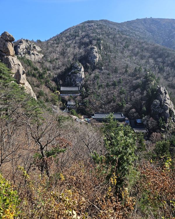 A temple complex in a rocky valley below Bongjeongam in Seoraksan, seen from the trail