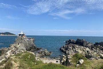 Orangdae coast in Busan with a small lighthouse on the rocks