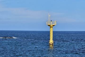 A yellow marker buoy on the blue East Sea off Sacheonjin